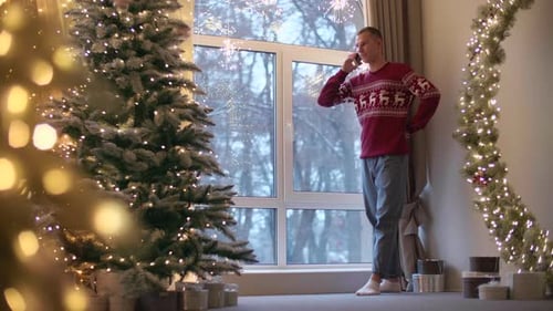 Man Talking on Phone at Christmas in Living Room