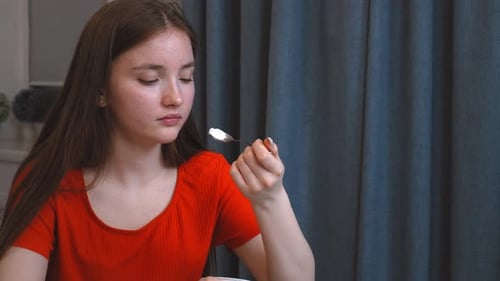 Woman Eating Yogurt at Home