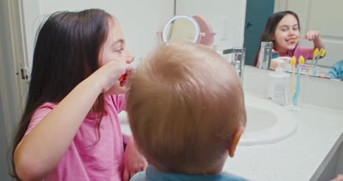 Kids Brushing Teeth in a Bathroom