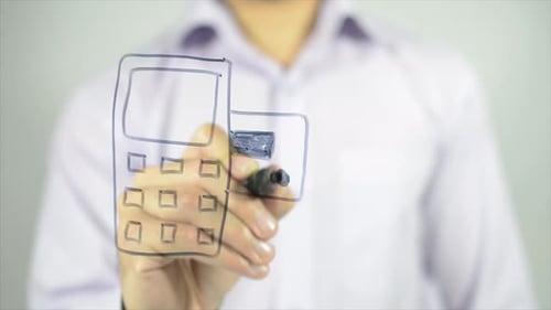 Man Drawing Payment Terminal on Clear Surface