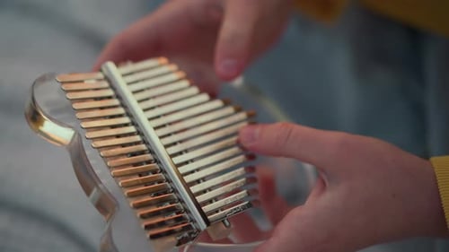 Intimate Kalimba Practice Upclose View of Fingers Practicing Kalimba Indoors An Intimate Scene of