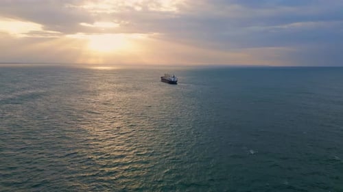 Aerial View Ship Sailing to Picturesque Sunset . Big Transportation Vessel