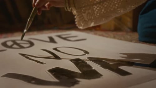 Hands of Anonymous Peace Protesters Painting Poster for Rally