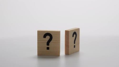 Two wooden blocks with a question mark on them