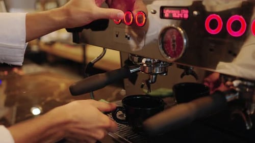 4K Barista making hot coffee on coffee maker at coffee shop.