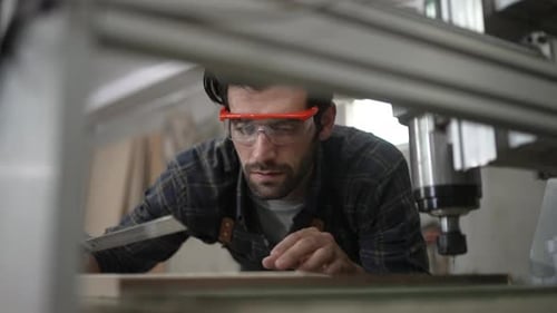 Carpenter is working at workshop.