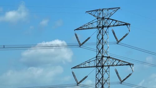 Aerial drone view of a high-voltage transmission tower.
