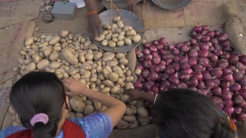 Women buying potatoes from a vendor during the lockdown placed in a rural town of Bihar due to the C