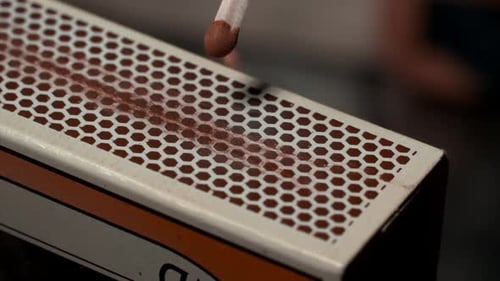 Close-up Shot Of A Match Being Lit On A Matchbox