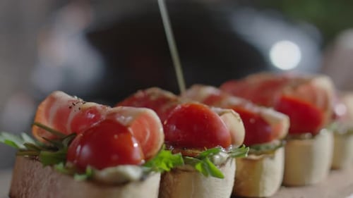 Fresh Appetizers with Tomatoes and Prosciutto Being Prepared