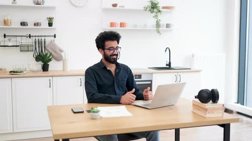 Man Smiles and Gives Thumbs Up on Video Call