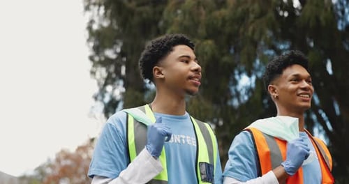 Nature, volunteer and men with garbage bag in park for environment, cleaning and community service
