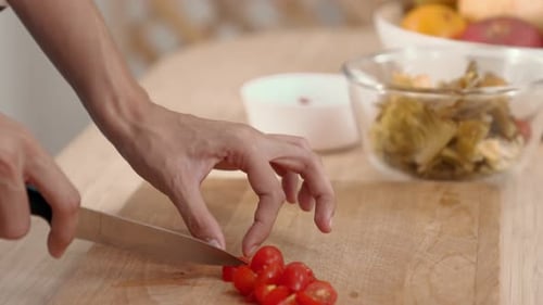 Close Up Hands Holding a Knife Preparing a Contented Meal