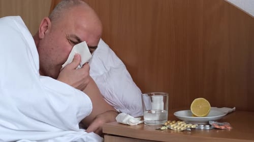Sick Man in Bed With Cold and Flu