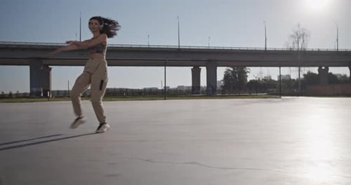 Woman Dancing Outside in an Urban Environment