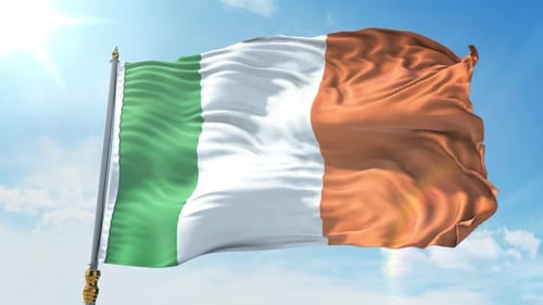 Waving Irish National Flag on Flagpole Against Sunny Blue Sky