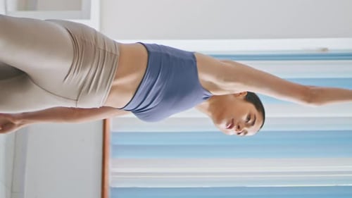 Woman Stretching and Exercising in Fitness Clothing