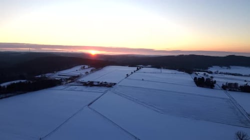 Aerial View of Snowy Fields at Sunrise