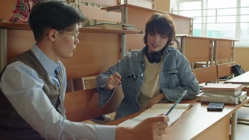 Young Adults Studying Together in Classroom