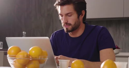 A man at home uses her laptop to: send work mails, shop online, surf on social networks. Concept o