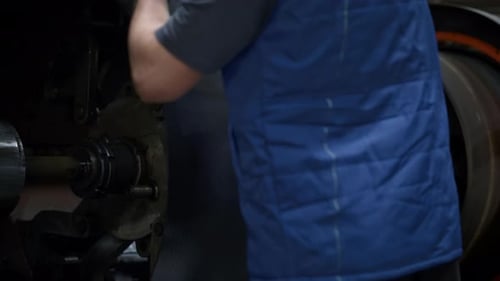 Tyre factory employee operating rubber tape machine in modern automotive industry