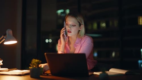 Woman Working Late on Laptop and Phone