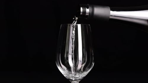 White Wine Being Poured into Glass Close Up