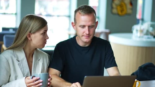 Colleagues Working Together on a Laptop