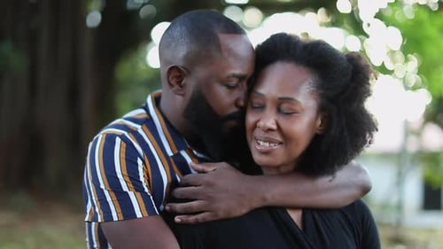 Beautiful loving black African relationship at park embrace