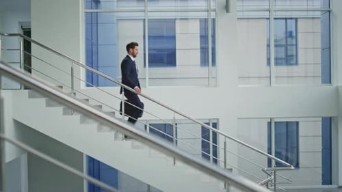 Business Owner Walking Down Stairs Hurrying Home After Work Day Successful Man