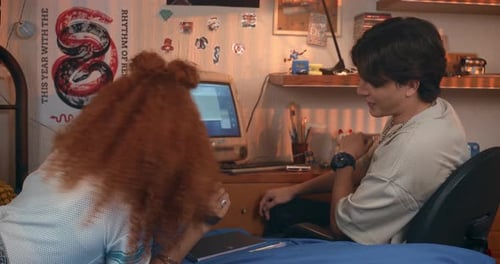 Teenage Girl and Boy Hanging Out in Bedroom