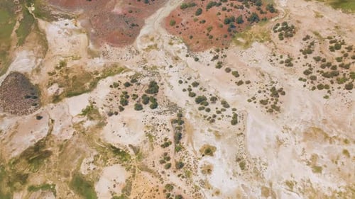 Dry rocky landscape with scarce greenery. Travertine Hot Springs scenery from drone footage