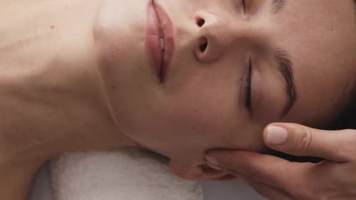 Face Massage Closeup of a Young Woman Getting Spa Treatment