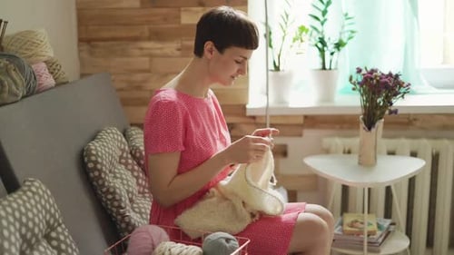 Woman Knitting at Home in Cozy Setting