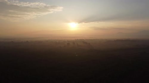 Aerial view of sky and sunlight during beautiful sunrise with clouds and fog in the morning.