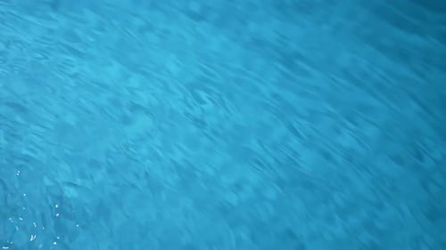 Beautiful Blue Transparent Water Surface Flowing Fast As Stream and Creating Circles and Waves Slow