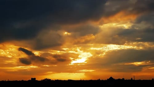 Dramatic Sunset with Dark Clouds and Golden Sky