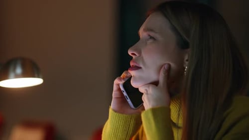 Stressed Woman Talking on Phone at Night Indoors