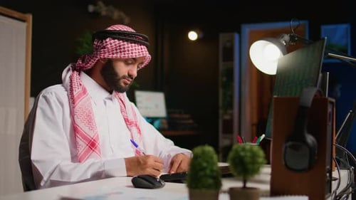 Adult Typing at Computer in Office at Night