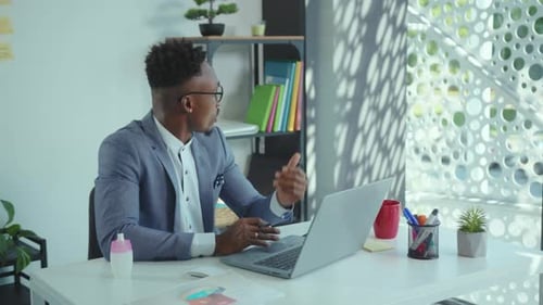 NEW YORK April 5 2020 African American Man Office Worker Sitting at Table and Having Videochat on