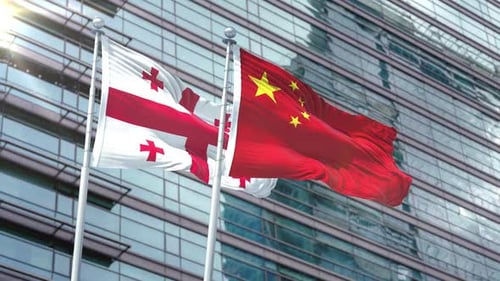 Realistic Georgia and China Flags Waving on Modern Building