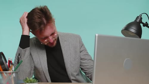Man at Desk Experiencing Headache and Stress
