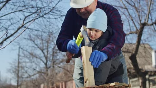The Bond Between a Grandfather and Grandson is Strengthened While Working in the Garden