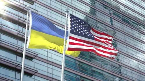 United States and Ukraine Flags Waving on Corporate Building
