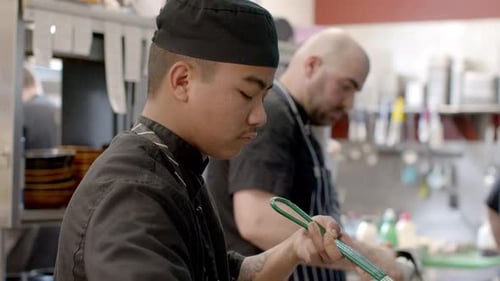 the chefs and crew are busy cooking orders in the kitchen. culinary industry. 4K