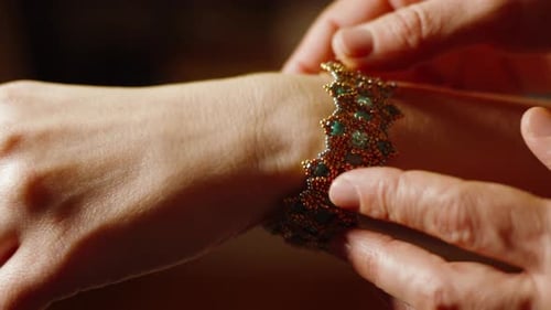 Beaded bracelet carefully placed on the wrist. Close-up.
