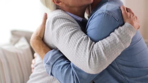 Senior Couple Embracing in a Bright Home Interior
