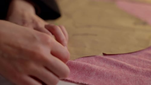 Hands Pinning Fabric Pattern for Sewing Project