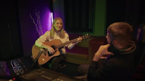 Talented Female Musician Playing Guitar for Sound Producer in Recording Studio Audition and Casting