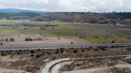 Aerial view cars on the highway in the field 4K